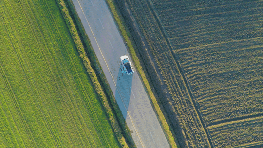 Stock video of car driving aerial view