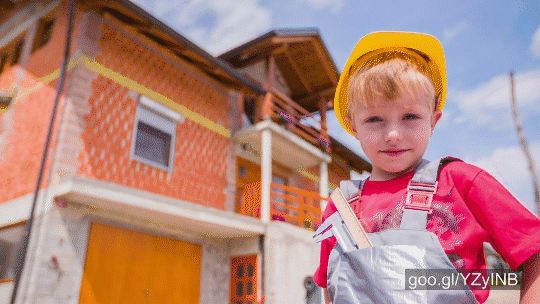 Stock footage of Cute Boy Portrait With Helmet And House In Background