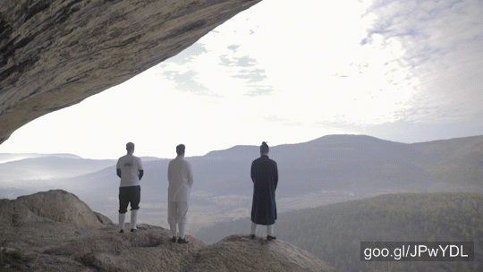 Stock Footage of Three Martial Arts Person Looking At Landscape View From Cliff 4K