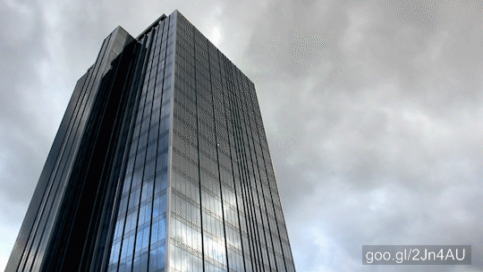 Stock Footage of Business Skyscraper Under Storm Clouds Time Lapse