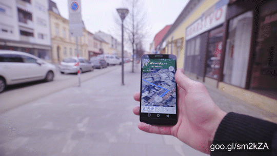Personal point of view holding smartphone in hand in focus showing map with path to destination.
